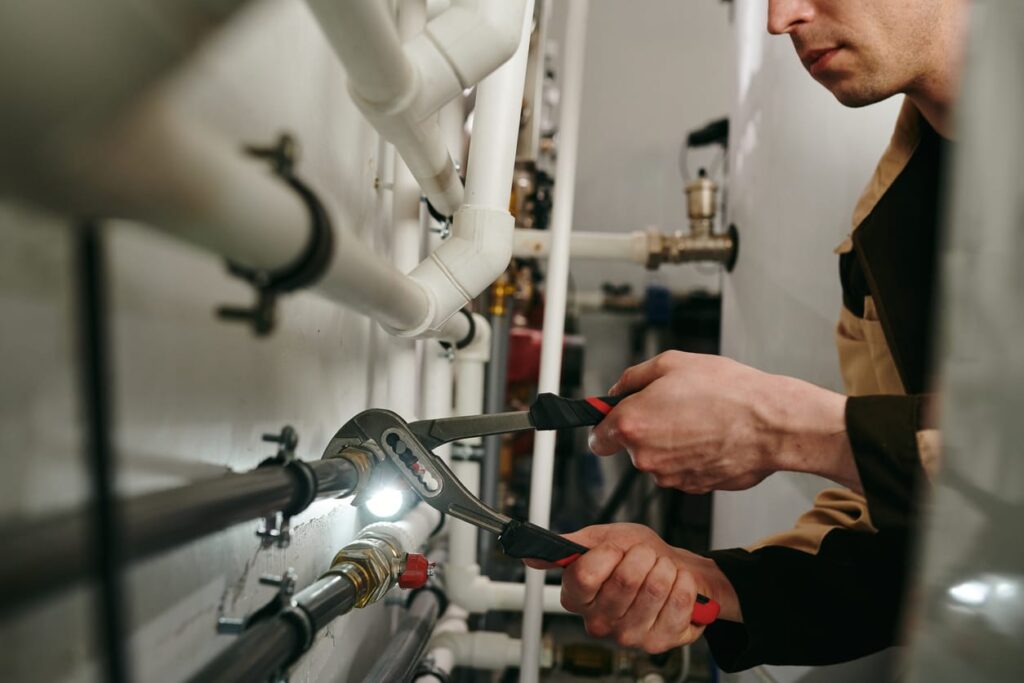 Plumbers maintaining commercial plumbing pipes in Canton
