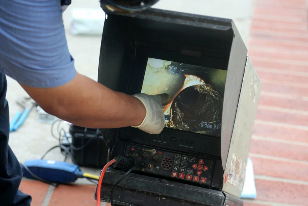 Technician viewing a drain inspection camera in Canton